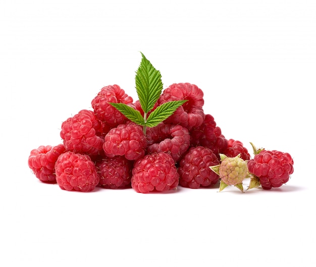 Red ripe raspberries and green leaves