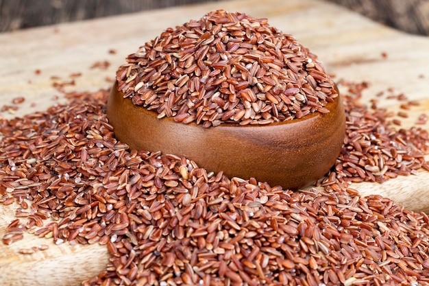 Red ripe rice raw uncooked red rice unpeeled to preserve the beneficial properties of cereals