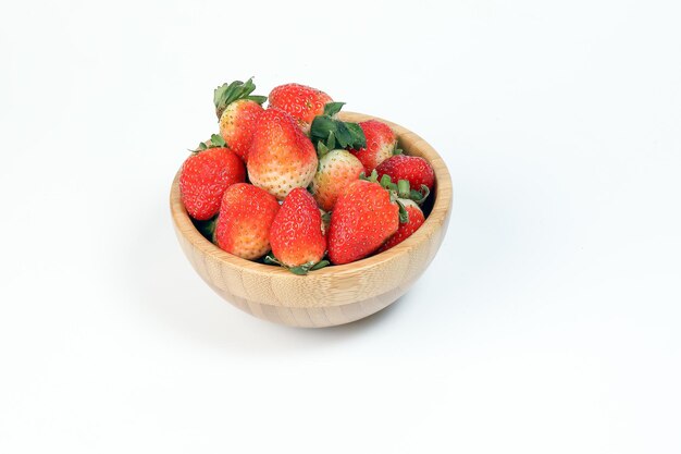 Red Ripe Strawberry in wooden bowl on white background