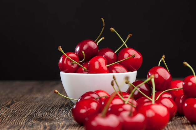 Red ripe sweet cherries on a wooden table, ripe red cherries of large size