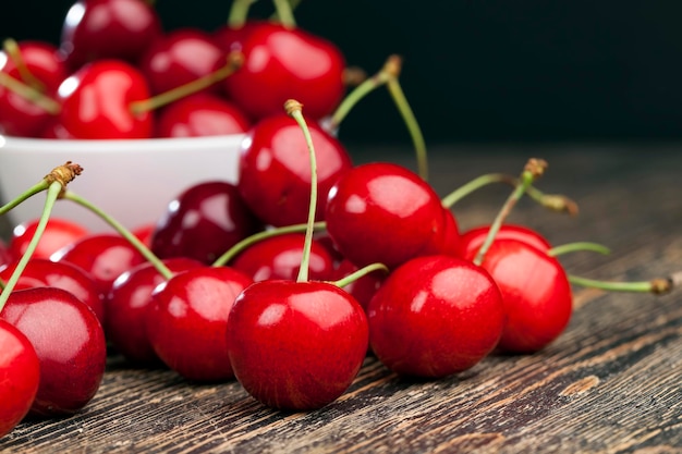 Red ripe sweet cherries on a wooden table