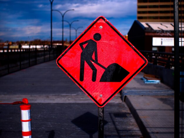 Red road sign against blue sky