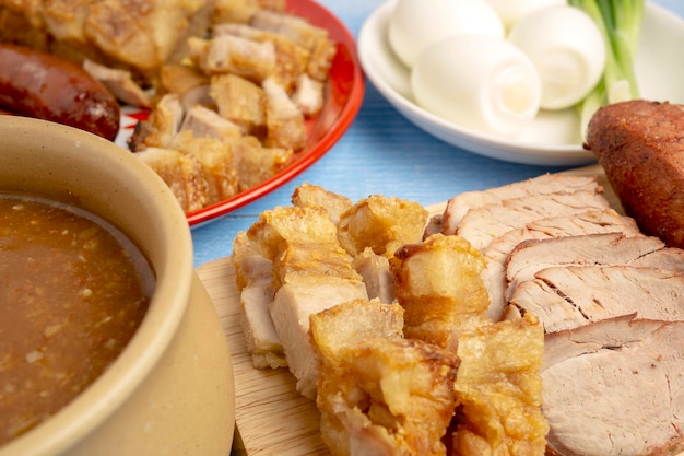 Red Roasted Pork Crispy Pork with Side Dish of Pork Sausage Boiled Egg and Gravy Sauce