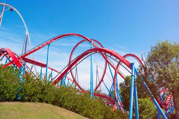 Red roller coaster in Barcelona Spain Port aventura amusement park Salou Steel Dragon Khan The track is red with white and pastel blue supports