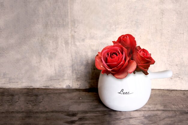 Red Rose flower In pot on vintage Background.