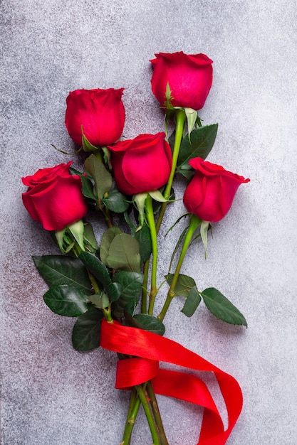 Red rose flowers bouquet on stone. Valentine's day