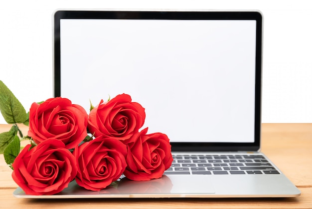 Red rose and laptop mockup on white 