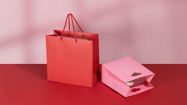 Photo red and rose paper shopping bags mockup