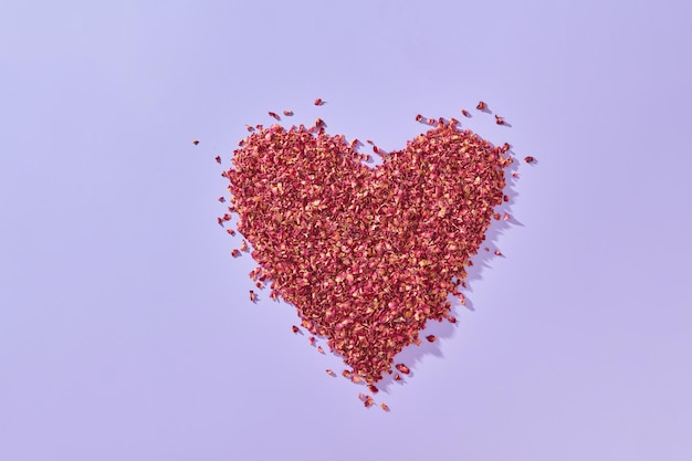 Red rose petals shaped as heart