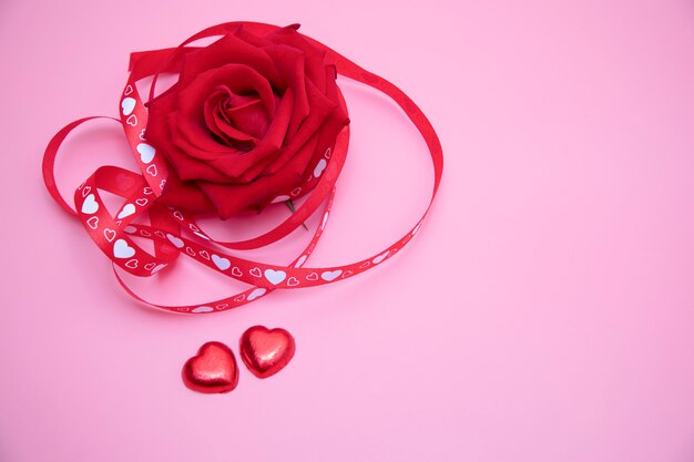 A red rose on pink background