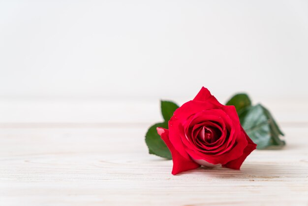 red rose on wood background with copyspace