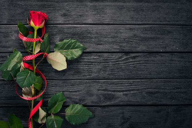 Red rose on a wooden background. Valentines day. Love. Top view. Free space for your text.