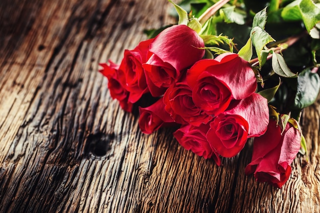 Red Roses. Bouquet of red roses free lying on rustic oak table.