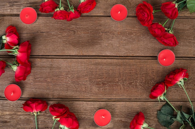 Red roses bouquet over wooden table top view with copy space flowers