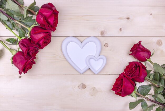 Red roses and a heartshaped photo frame