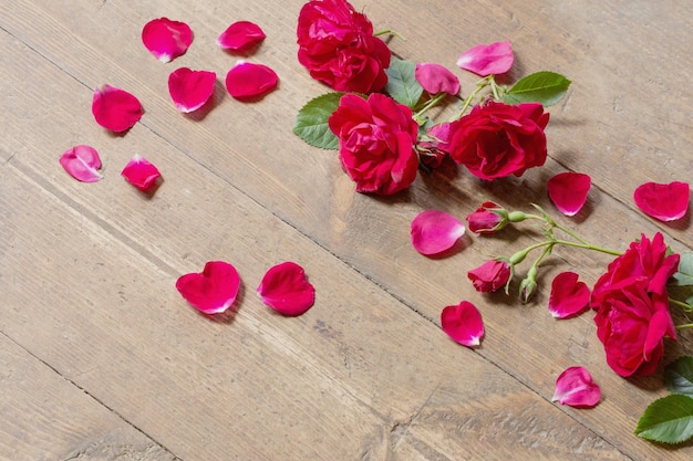 Red roses on old wooden background