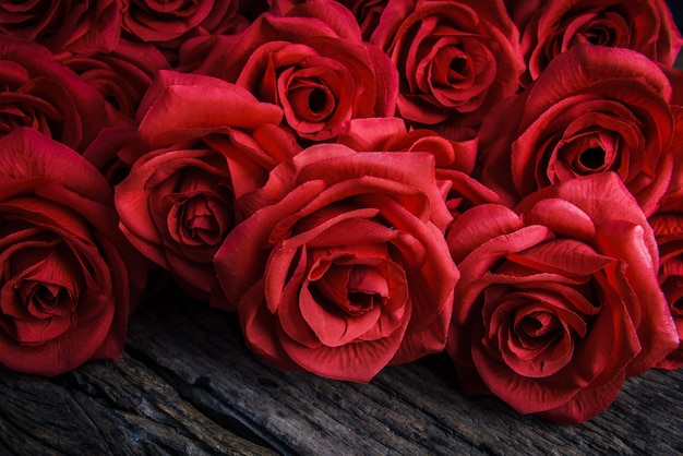 Red Roses on old wooden board, Valentines Day background, wedding day