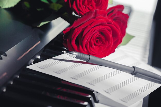 Red roses on piano keys