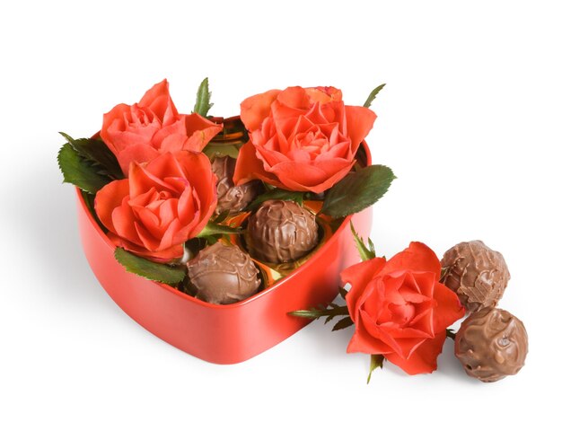 Red roses and truffles in a heart-shaped box