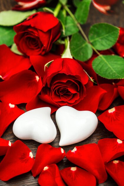 Red roses and two white hearts. Valentines Day decoration