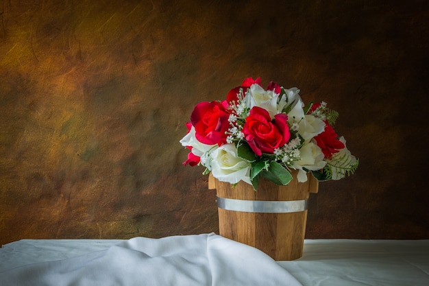 Red roses and white roses artificial on a white background