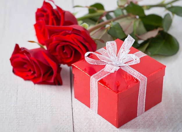 red roses with decorative hearts and presents