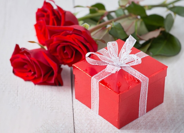 red roses with decorative hearts and presents