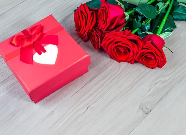 red roses with decorative hearts and presents