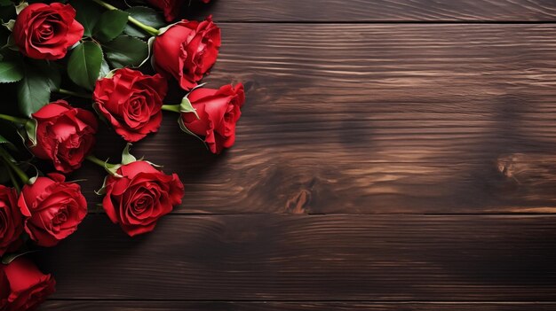 red roses on wooden background top view