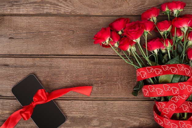 Red roses on wooden board valentines day background