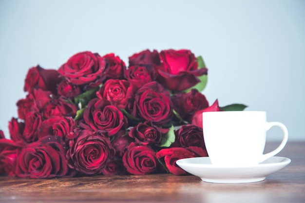 Red rosses with cup of coffee