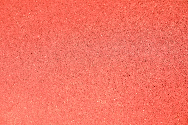 Red rubber running track background, top view