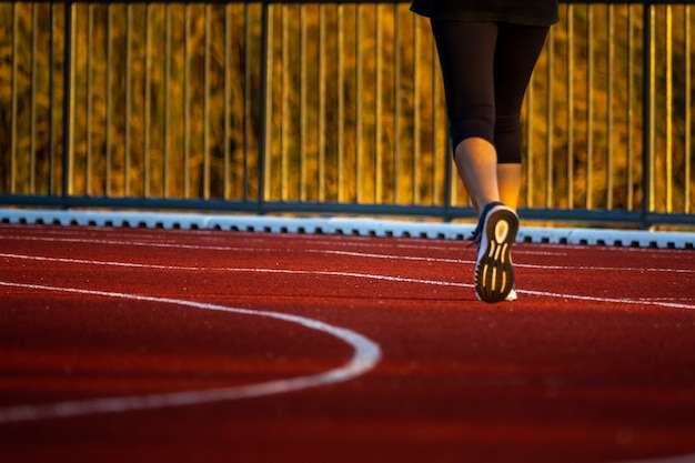 Red running track with runner's feet