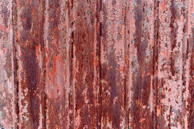 Red, rusty background with peeling paint.