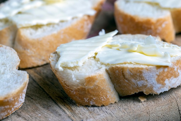 Red salmon or trout caviar with white baguette and butter making sandwiches with loaf butter and red real caviar