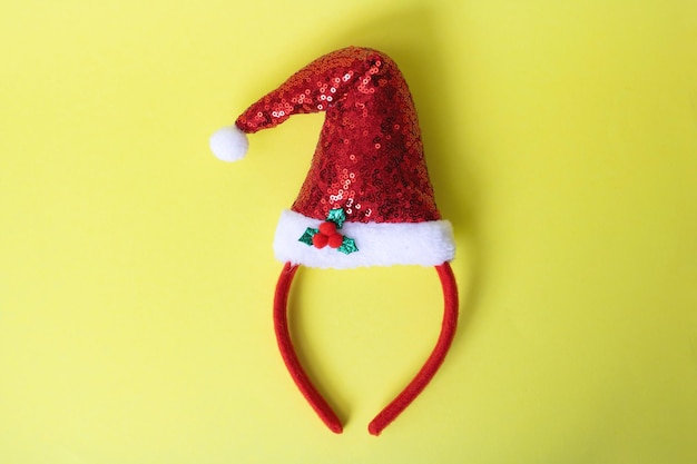 Red Santa Claus hat on yellow background