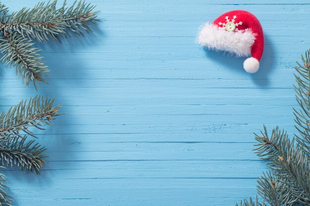 Red santa hat on blue wooden background