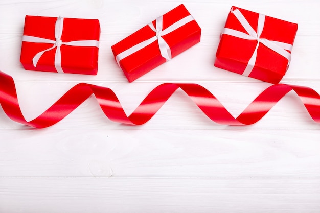 Red satin ribbon and box isolated on white background