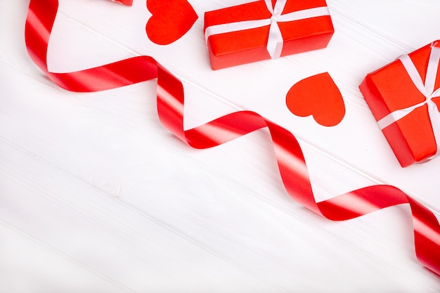 Photo red satin ribbon and box isolated on white background