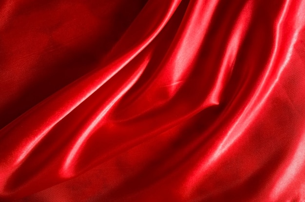 Red satin or silk fabric as background.