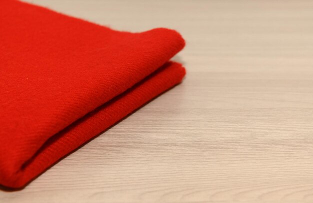 Photo red scarf on a wooden background with space for text