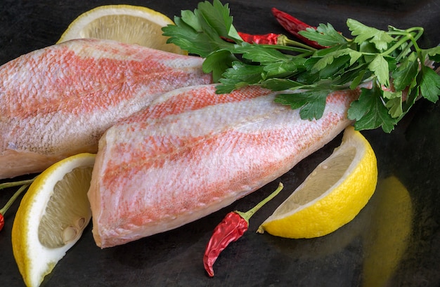 Red sea bass fish on black background.