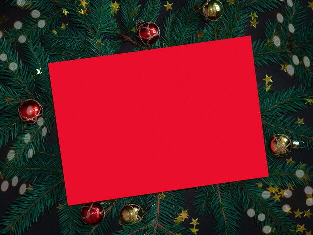 Photo a red sheet of paper on a christmas background with space for text a glider for the new year