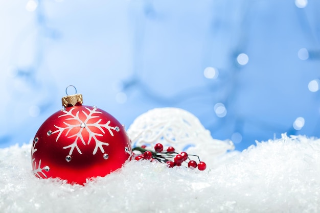 Red shiny christmas balls in snowflakes