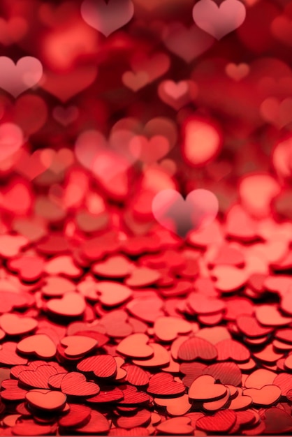 Red shiny empty background of confetti hearts blur it is suitable for creating a valentine card or p...