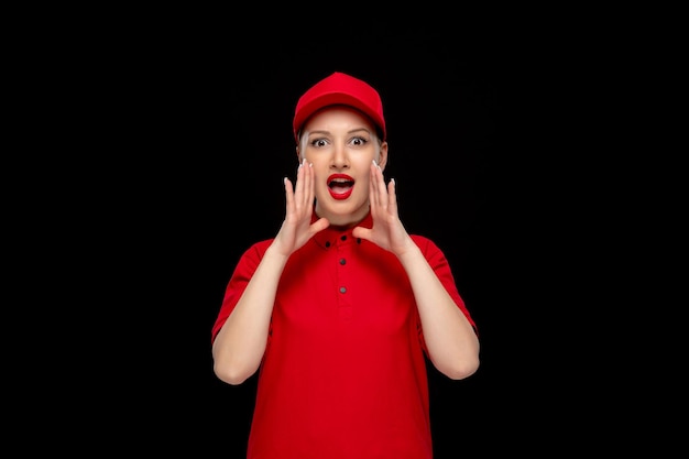 Red shirt day young girl putting hands around mouth in a red cap wearing shirt with lipstick