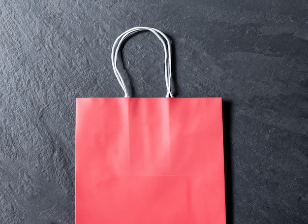 Red shopping bag on dark background black friday concept