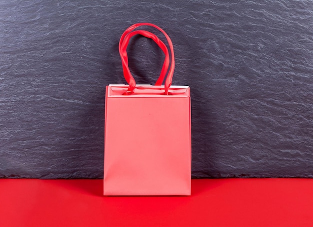 Red shopping bag on dark background Black Friday Concept