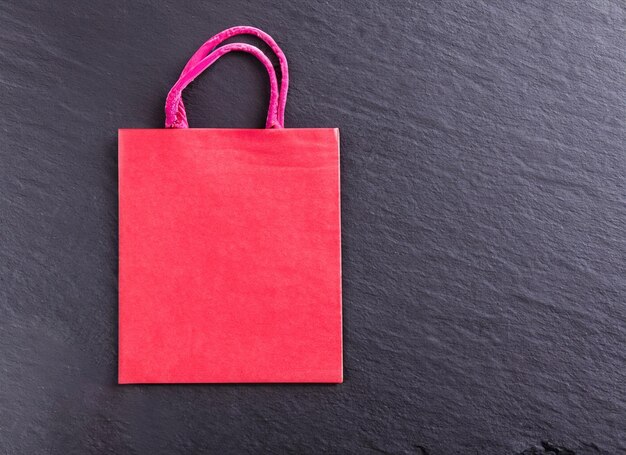 Red shopping bag on dark background Black Friday Concept