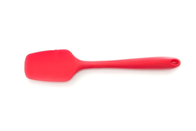 Red silicone spatula isolated on white background.